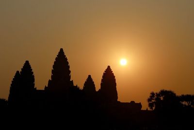 Silhouette temple against sky during sunset