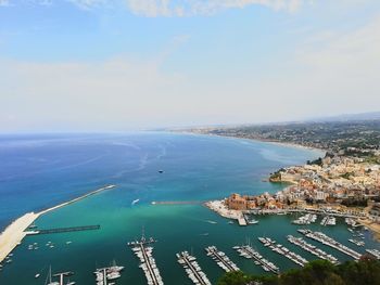 High angle view of sea and city against sky