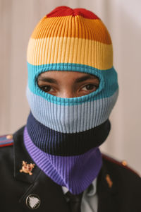 Close-up portrait of young woman wearing knit hat