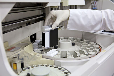 Cropped hand of scientist holding equipment at laboratory