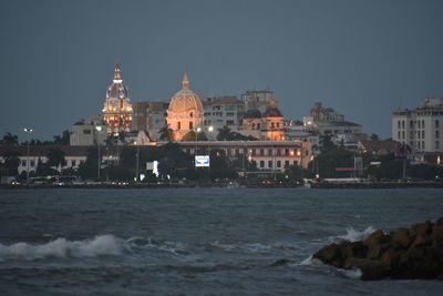 View of city lit up at waterfront