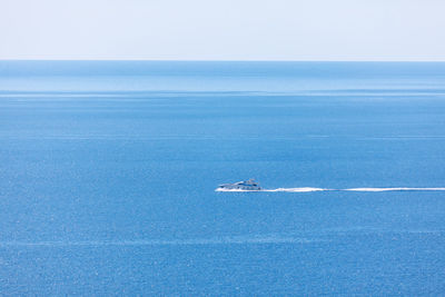Speed boat on the blue water . fast boat sailing . trail on the water