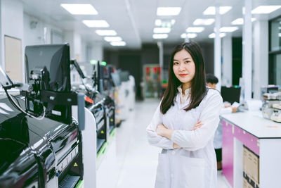 Portrait of young woman standing in shopping mall