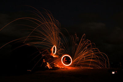 Wire wool against sky at night