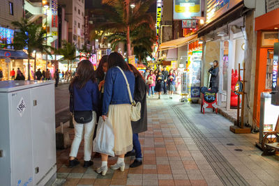 People on city street at night