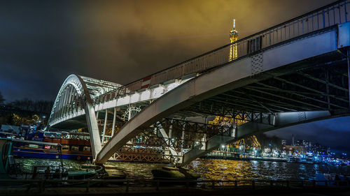 View of bridge over river at night