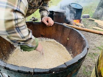 Midsection of man preparing food in workshop