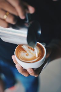 Close-up of hand holding coffee cup