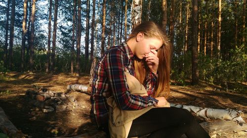 Portrait of teenage girl sitting outdoors