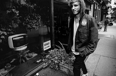 Portrait of young man standing at market