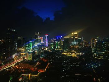 High angle view of illuminated buildings in city at night