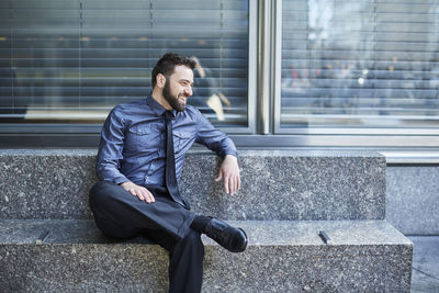 Young man sitting outdoors
