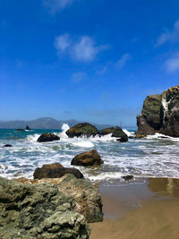 Rocks on beach against sky