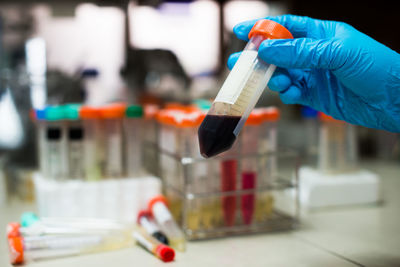 Cropped hand examining in laboratory