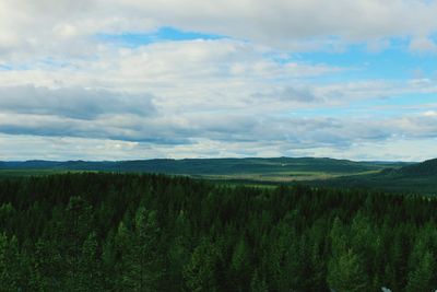 Scenic view of landscape against cloudy sky