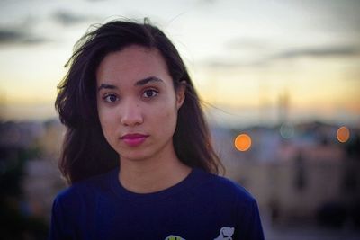 Portrait of beautiful young woman at sunset