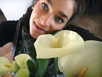 Portrait of smiling woman holding flower