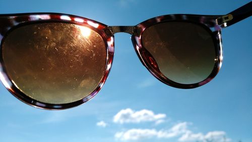 Low angle view of sunglasses against sky