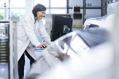 Female technician using computer in laboratory