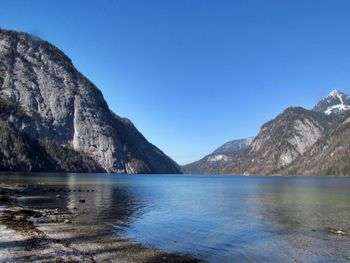 Scenic view of calm lake against clear blue sky