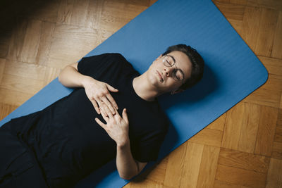 High angle view of woman sitting on floor