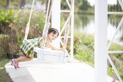 Young woman sitting on swing