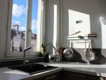 Sink at kitchen counter by window