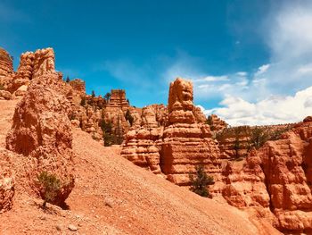 Rock formations on landscape against sky