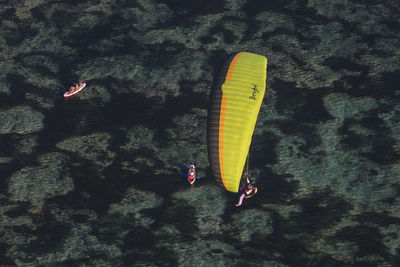 Person paragliding against sea