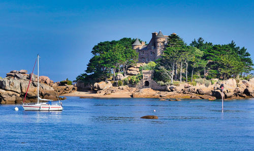 Scenic view of sea against buildings