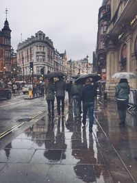 People on wet road during rainy season