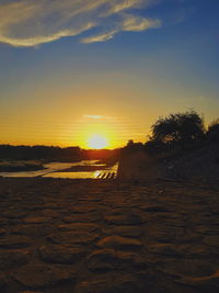 Scenic view of beach against sky during sunset