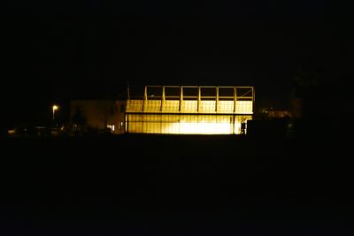 Illuminated built structure against clear sky at night