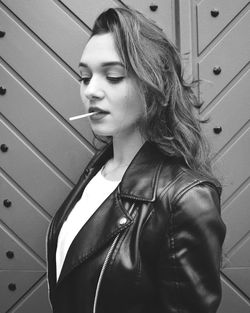 Close-up of young woman eating lollipop