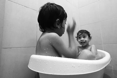 Boy in bathtub at home