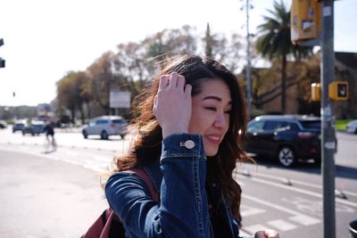 Beautiful young woman on street in city