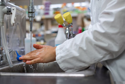 Midsection of man working in kitchen