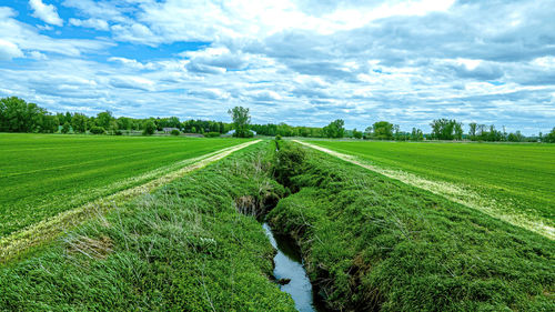 A cloudy blue sky hovers over a farm fields in rural wisconsin usa