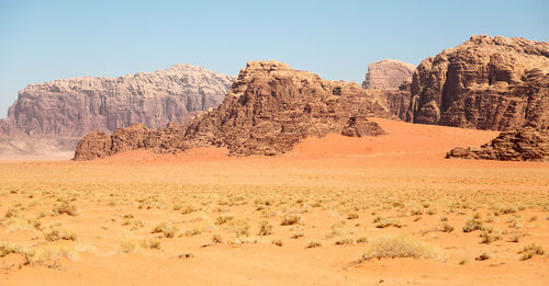 View of arid landscape against clear sky