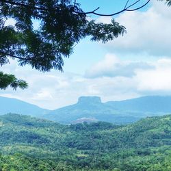 Scenic view of mountains against cloudy sky