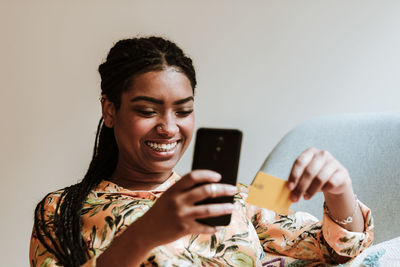 Ethnic woman shopping online at home