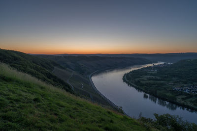 Scenic view of landscape against clear sky during sunset