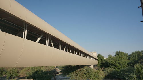 Low angle view of bridge against clear blue sky