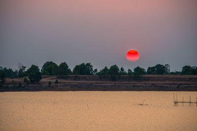 Scenic view of field against sky during sunset