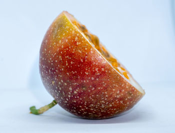 Close-up of apple on table against white background