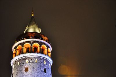 Close-up of illuminated cathedral against sky at night