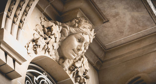 Low angle view of statue against wall