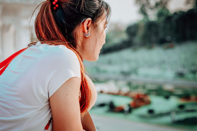 Close-up of woman sitting outdoors