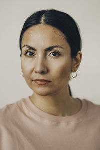 Portrait of mid adult woman against white background