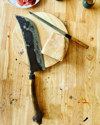 High angle view of cutting board on wooden table